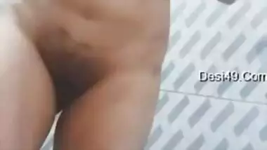 Big-tittied Desi gal strips and XXX pleases herself with fingering